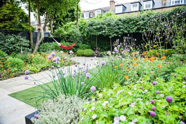 Garden with Stone terrace pathways in Wandsworth designed by Sarah Hammond constructed by the Garden Builders, classical high quality finish and low maintenance.