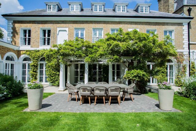 A grand residential garden in Fulham designed and built by The Garden Builders, a relaxing family garden, terrace for fun, outdoor entertainment space with lawn.
