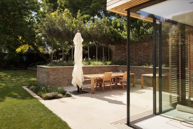 Large Grand Garden design includes York stone and wooden family pavilion in Notting Hill west London Landscape design company Ladbroke Grove Westbourne Grove.