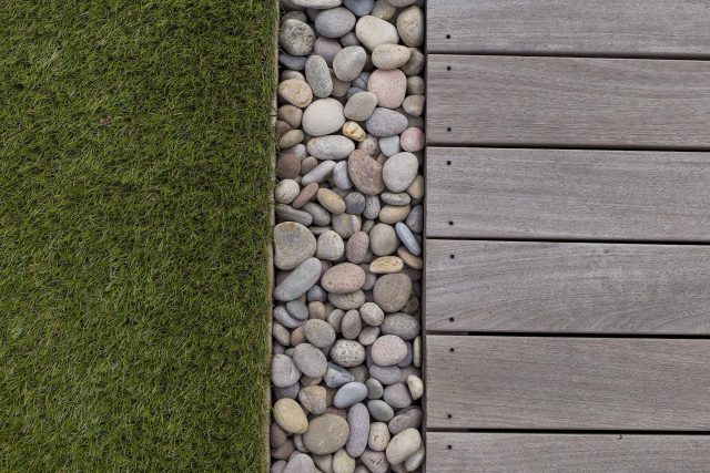 Roof terrace with decking, artificial level lawn and LED lighting design at New Concordia Wharf, highlight surfaces and architectural elements in the evenings.