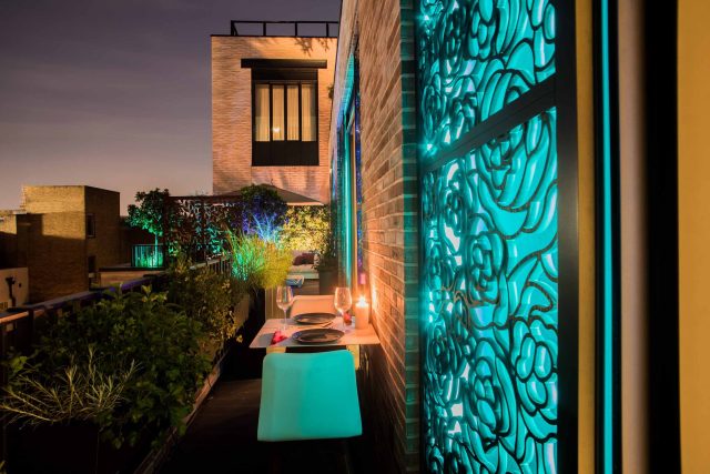 Roof terrace design Covent Garden composite decking luxurious entertaining in the heart of London with contemporary furniture a bio-fuel burning fire table.