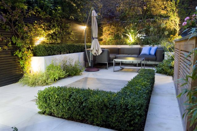 Outdoor room in Sloane Square Chelsea with Gloster exterior furniture and lighting and timber decking, roof terrace designer, sandstone paving raised beds.
