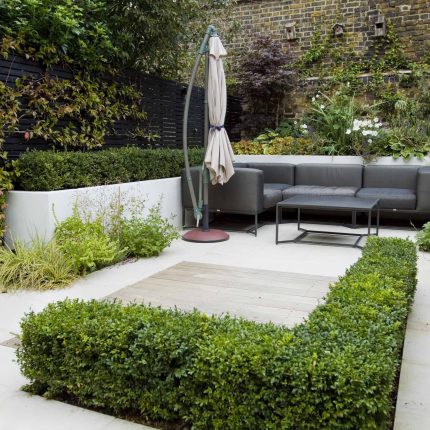 Outdoor room in Sloane Square Chelsea with Gloster exterior furniture and lighting and timber decking, roof terrace designer, sandstone paving raised beds.
