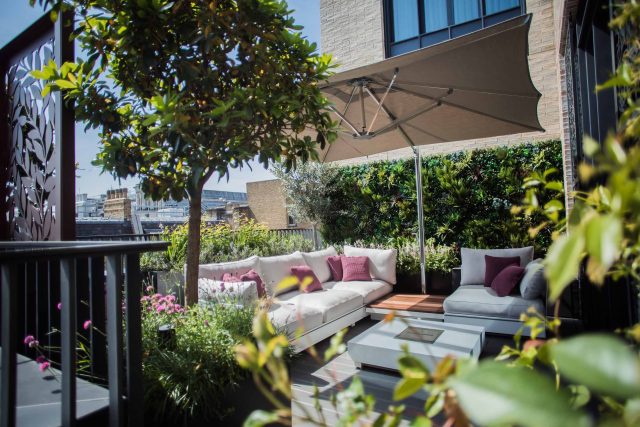 Roof terrace design Covent Garden composite decking luxurious entertaining in the heart of London with contemporary furniture a bio-fuel burning fire table.