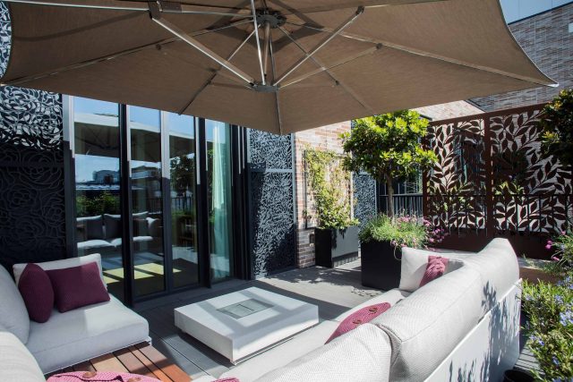 Roof terrace design Covent Garden composite decking luxurious entertaining in the heart of London with contemporary furniture a bio-fuel burning fire table.