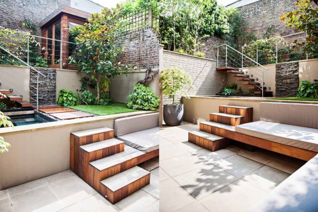 City design jacuzzi garden low maintenance with artificial lawn, stacked stone water wall BBQ Fire place feature, Hampstead Village, natural stone led lighting.
