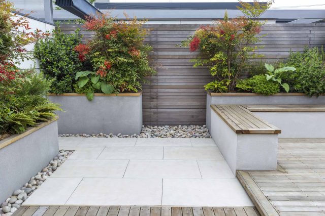 Roof Terrace garden Design for a penthouse apartment King's Cross development, expanse decking storage benches, planters, cedar deck seating area outdoor room.