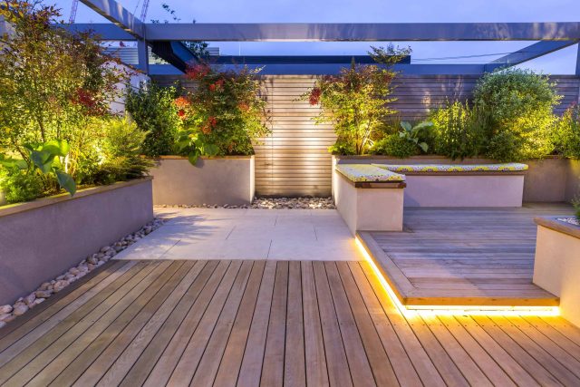 Roof Terrace garden Design for a penthouse apartment King's Cross development, expanse decking storage benches, planters, cedar deck seating area outdoor room.