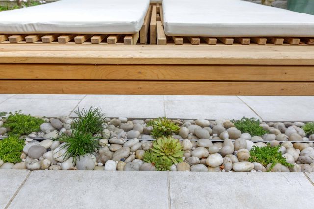 Garden design Vauxhall South London outdoor space, hidden LED strip lighting, polished white pebbles, porcelain paving steps tiles stand slatted cedar trellis.