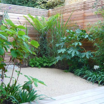 Islington ground floor garden Cedar slatted design screens were constructed and fixed onto existing perimeter fencing, landscaping finishes, seasonal planting.