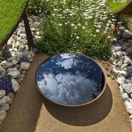 The World Vision Garden, Gold Medal Winning garden at RHS Hampton Court Palace Flower Show, The design of the garden is a horticultural interpretation London.