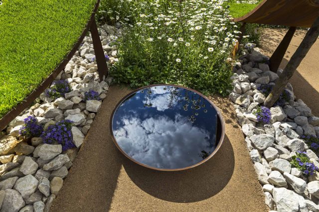 The World Vision Garden, Gold Medal Winning garden at RHS Hampton Court Palace Flower Show, The design of the garden is a horticultural interpretation London.