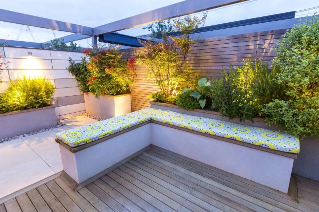 Roof Terrace garden Design for a penthouse apartment King's Cross development, expanse decking storage benches, planters, cedar deck seating area outdoor room.