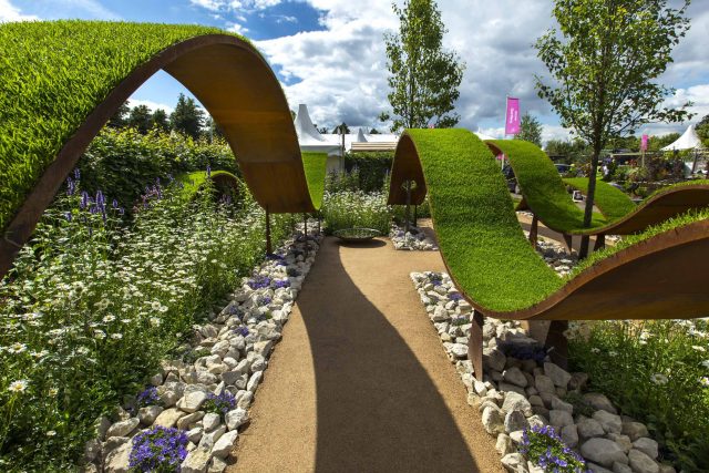 The World Vision Garden, Gold Medal Winning garden at RHS Hampton Court Palace Flower Show, The design of the garden is a horticultural interpretation London.