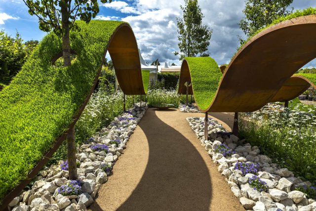 The World Vision Garden, Gold Medal Winning garden at RHS Hampton Court Palace Flower Show, The design of the garden is a horticultural interpretation London.