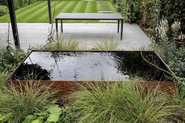 Garden designer contemporary family garden Chiswick friendly space decking, dining table, an aluminum pergola in powder-coated finish, a cozy and warm outlook.