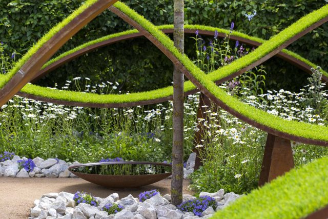 The World Vision Garden, Gold Medal Winning garden at RHS Hampton Court Palace Flower Show, The design of the garden is a horticultural interpretation London.