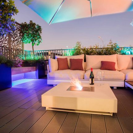 Roof terrace design Covent Garden composite decking luxurious entertaining in the heart of London with contemporary furniture a bio-fuel burning fire table.