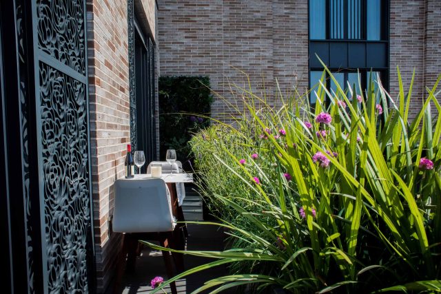 Roof terrace design Covent Garden composite decking luxurious entertaining in the heart of London with contemporary furniture a bio-fuel burning fire table.
