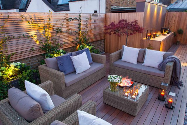 Roof terrace with decking, artificial level lawn and LED lighting design at New Concordia Wharf, highlight surfaces and architectural elements in the evenings.