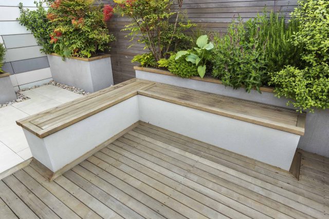 Roof Terrace garden Design for a penthouse apartment King's Cross development, expanse decking storage benches, planters, cedar deck seating area outdoor room.