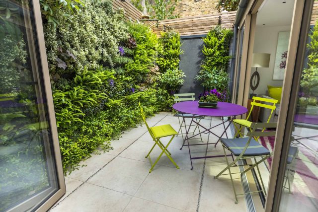 Kensington Courtyard Garden design, living green walls, illuminated with garden lighting in this limited space, a tapestry of green slatted red cedar trellis.