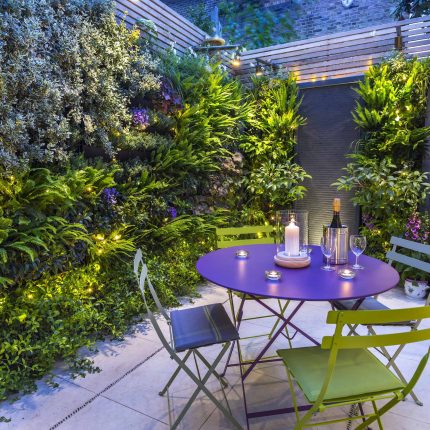Kensington Courtyard Garden design, living green walls, illuminated with garden lighting in this limited space, a tapestry of green slatted red cedar trellis.