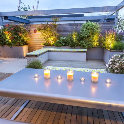 Roof Terrace garden Design for a penthouse apartment King's Cross development, expanse decking storage benches, planters, cedar deck seating area outdoor room.