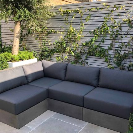 Wandsworth Garden designer initials Artificial Vertical Green Wall toward the rear of the garden breaks up the white of the adjoining trellis and creates space.