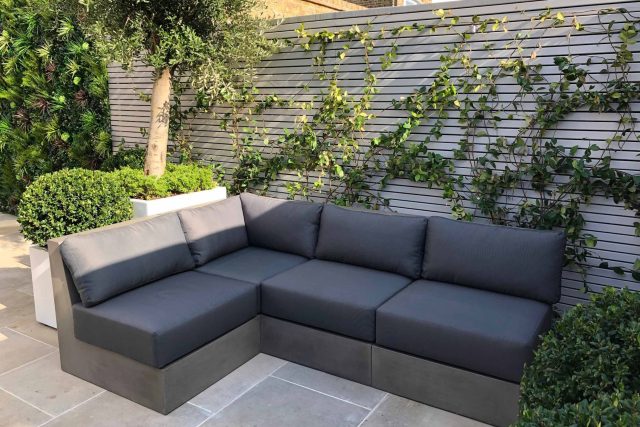 Wandsworth Garden designer initials Artificial Vertical Green Wall toward the rear of the garden breaks up the white of the adjoining trellis and creates space.