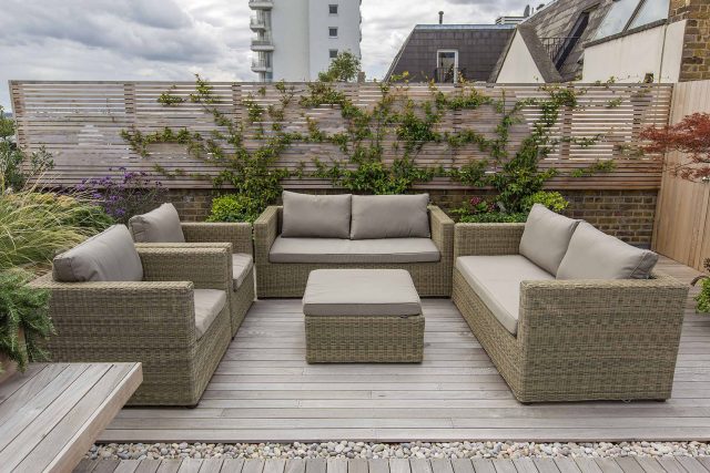 Roof terrace with decking, artificial level lawn and LED lighting design at New Concordia Wharf, highlight surfaces and architectural elements in the evenings.