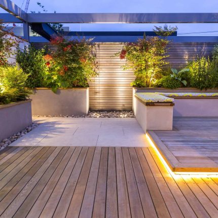 Roof Terrace garden Design for a penthouse apartment King's Cross development, expanse decking storage benches, planters, cedar deck seating area outdoor room.