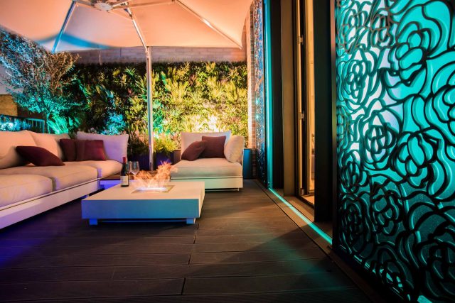 Roof terrace design Covent Garden composite decking luxurious entertaining in the heart of London with contemporary furniture a bio-fuel burning fire table.