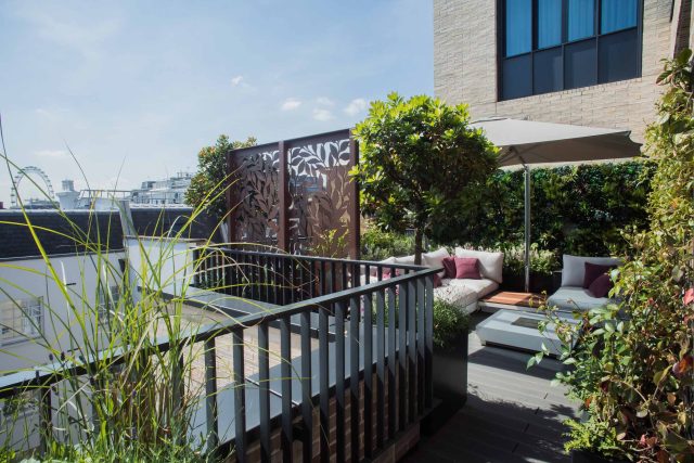 Roof terrace design Covent Garden composite decking luxurious entertaining in the heart of London with contemporary furniture a bio-fuel burning fire table.