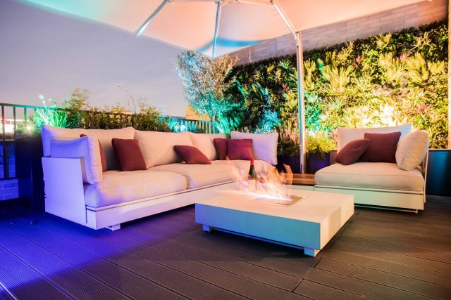 Roof terrace design Covent Garden composite decking luxurious entertaining in the heart of London with contemporary furniture a bio-fuel burning fire table.