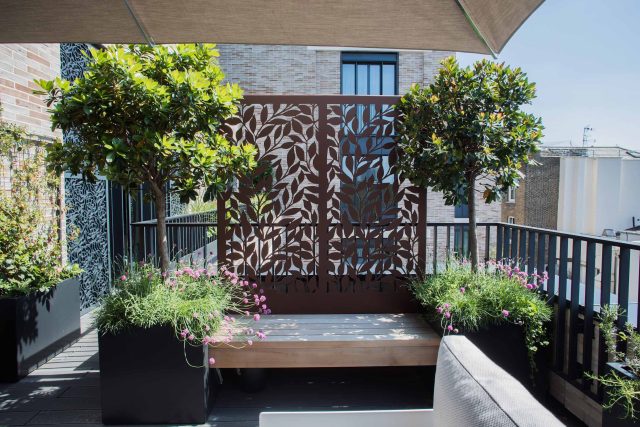 Roof terrace design Covent Garden composite decking luxurious entertaining in the heart of London with contemporary furniture a bio-fuel burning fire table.