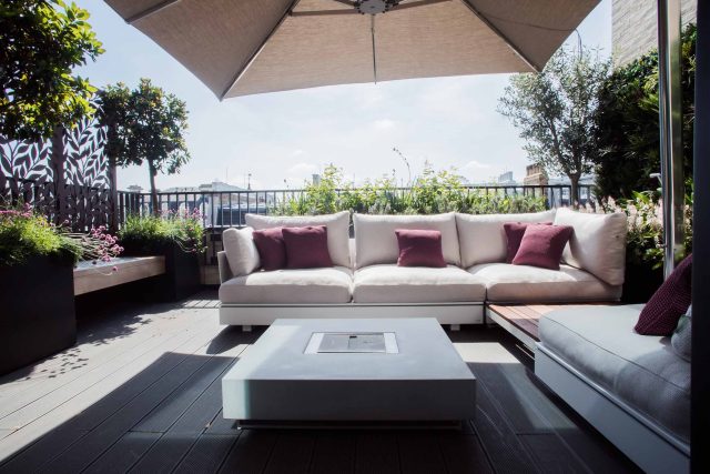 Roof terrace design Covent Garden composite decking luxurious entertaining in the heart of London with contemporary furniture a bio-fuel burning fire table.