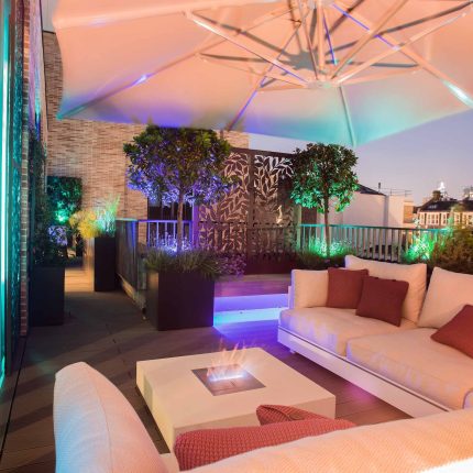 Roof terrace design Covent Garden composite decking luxurious entertaining in the heart of London with contemporary furniture a bio-fuel burning fire table.
