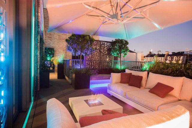 Roof terrace design Covent Garden composite decking luxurious entertaining in the heart of London with contemporary furniture a bio-fuel burning fire table.
