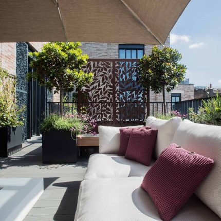 Roof terrace design Covent Garden composite decking luxurious entertaining in the heart of London with contemporary furniture a bio-fuel burning fire table.