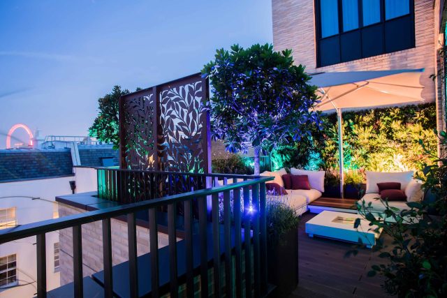 Roof terrace design Covent Garden composite decking luxurious entertaining in the heart of London with contemporary furniture a bio-fuel burning fire table.