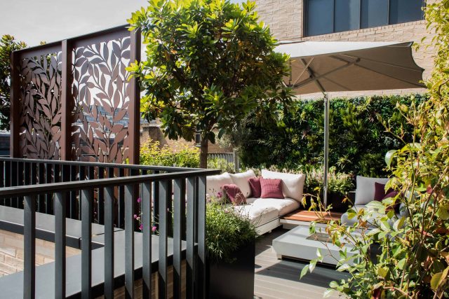 Roof terrace design Covent Garden composite decking luxurious entertaining in the heart of London with contemporary furniture a bio-fuel burning fire table.