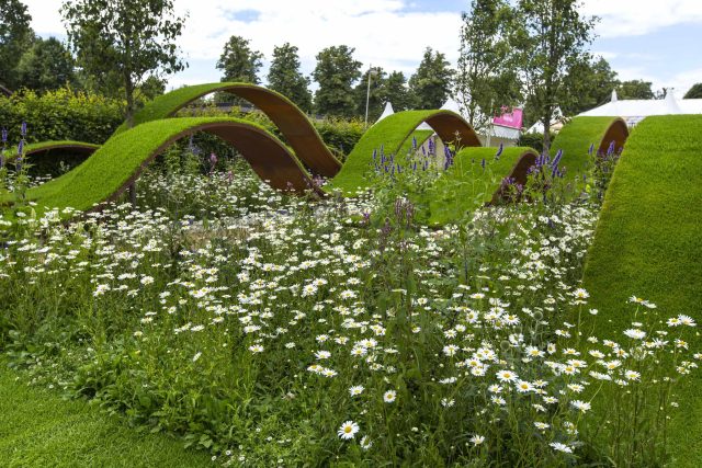The World Vision Garden, Gold Medal Winning garden at RHS Hampton Court Palace Flower Show, The design of the garden is a horticultural interpretation London.