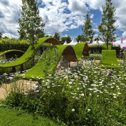 The World Vision Garden, Gold Medal Winning garden at RHS Hampton Court Palace Flower Show, The design of the garden is a horticultural interpretation London.