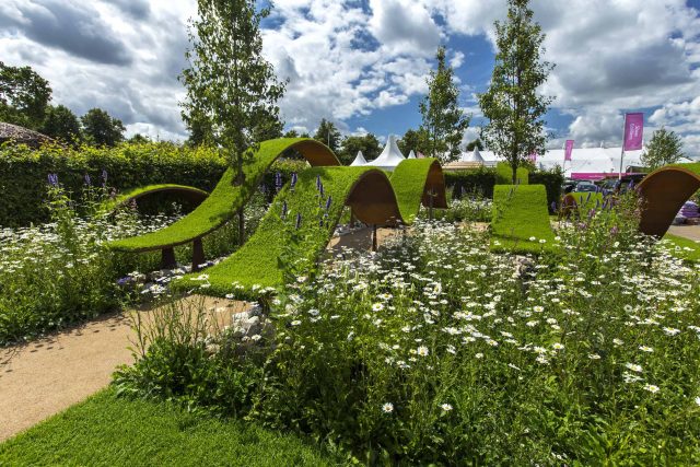 The World Vision Garden, Gold Medal Winning garden at RHS Hampton Court Palace Flower Show, The design of the garden is a horticultural interpretation London.