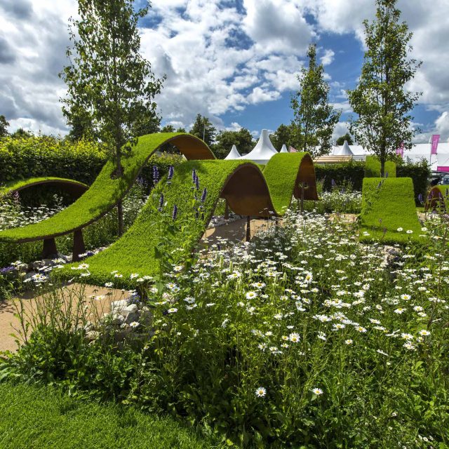 The World Vision Garden, Gold Medal Winning garden at RHS Hampton Court Palace Flower Show, The design of the garden is a horticultural interpretation London.