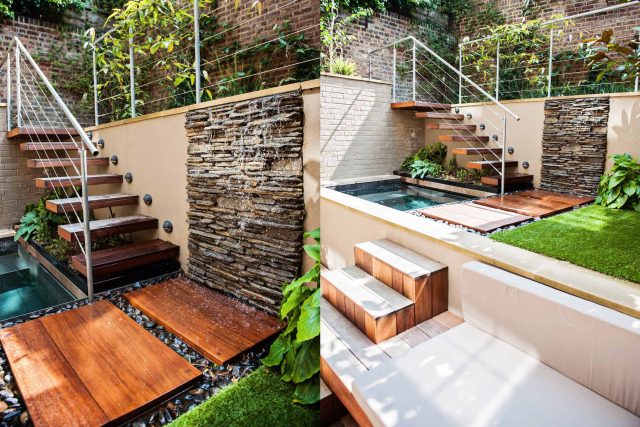 City design jacuzzi garden low maintenance with artificial lawn, stacked stone water wall BBQ Fire place feature, Hampstead Village, natural stone led lighting.