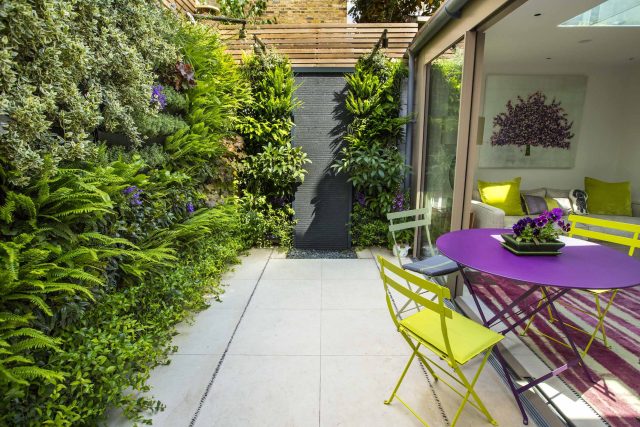Kensington Courtyard Garden design, living green walls, illuminated with garden lighting in this limited space, a tapestry of green slatted red cedar trellis.