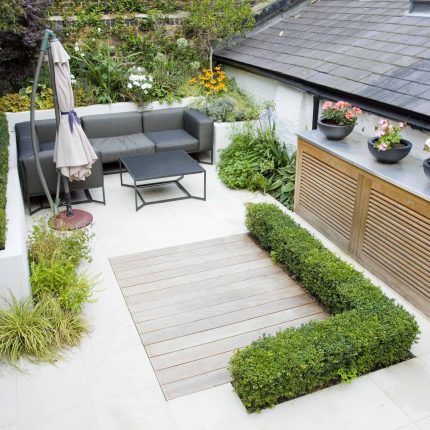 Outdoor room in Sloane Square Chelsea with Gloster exterior furniture and lighting and timber decking, roof terrace designer, sandstone paving raised beds.