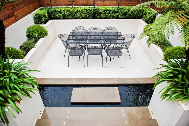Beautiful London Garden, Clancarty Road, London, new block rendered boundary walls, planting, lighting, submersible water lights, bright contemporary effect.